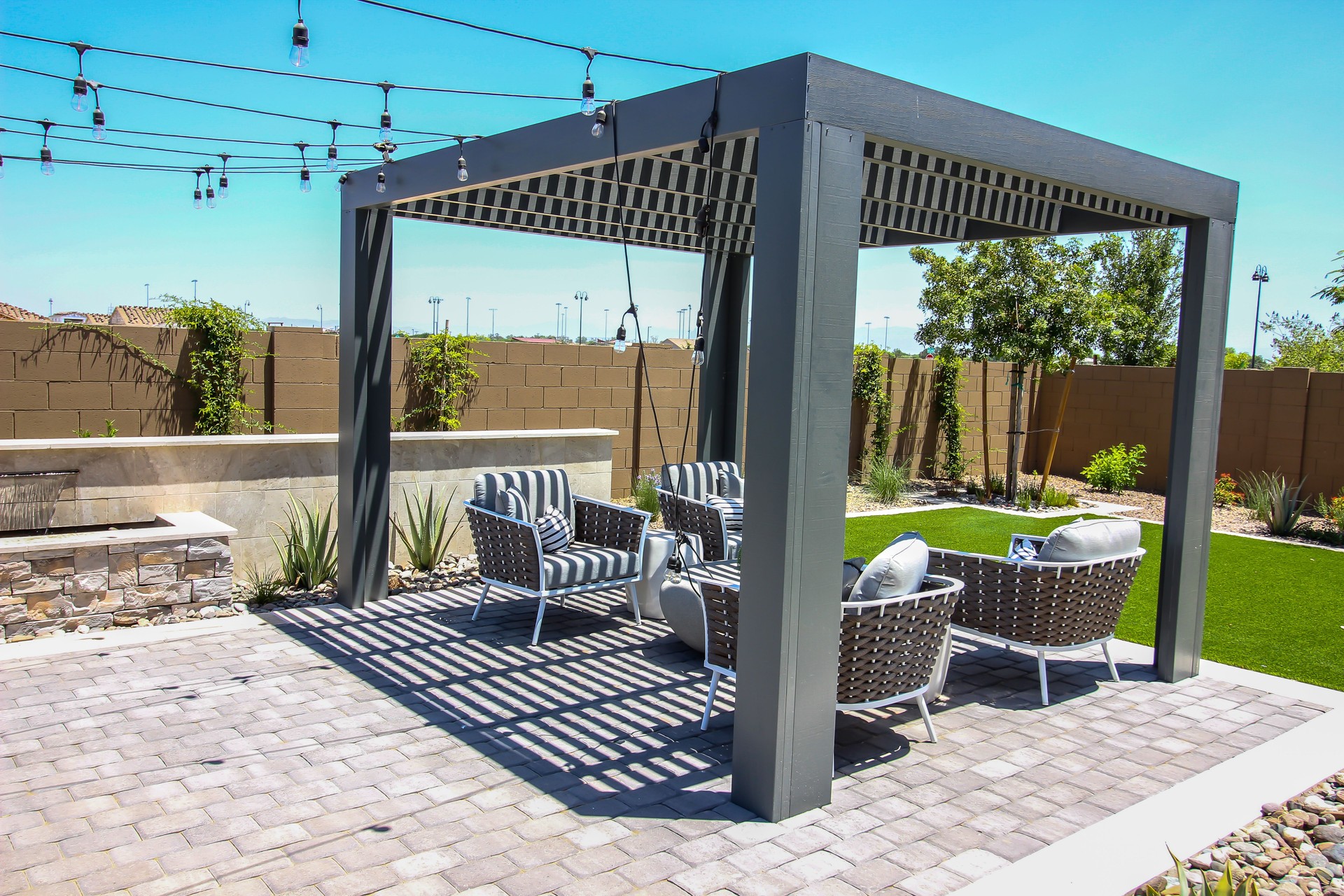 Lattice Pergola Covering Four Arm Chairs On Back Patio